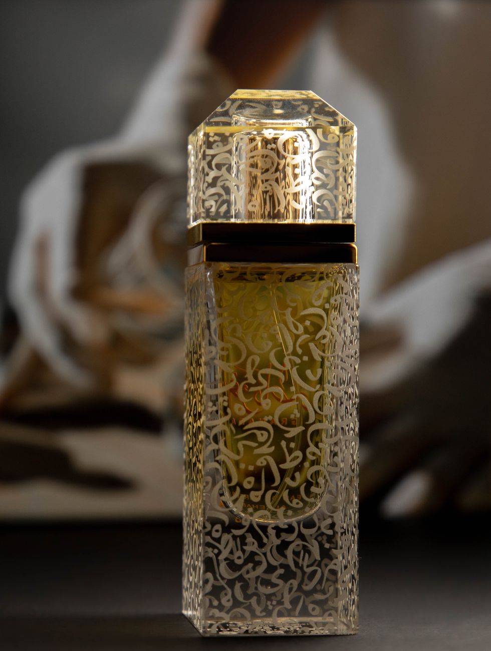close up shot of gold and clear perfume bottle